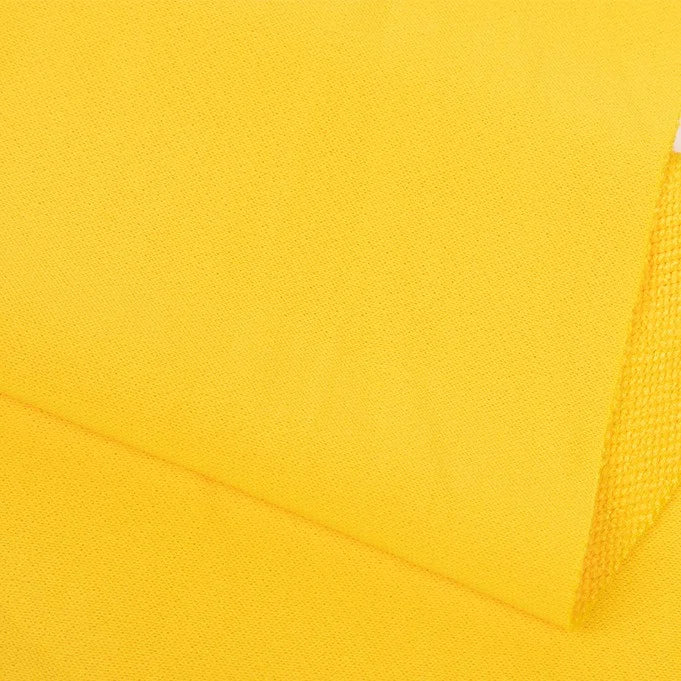 Close-up of Longan Craft Plain Color French Terry Fabric by the Yard, featuring bright yellow polyester with a textured, slightly rough surface and visible weave—ideal soft material for winter clothing.
