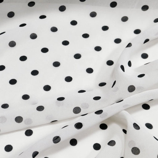 Polka Dot Print Chiffon Fabric By The Yard featuring a sheer white chiffon base with a black polka dot pattern.