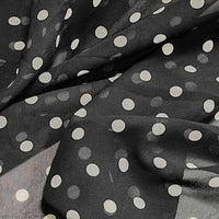 Sheer black polka dot chiffon fabric with a white print from Longan Craft.