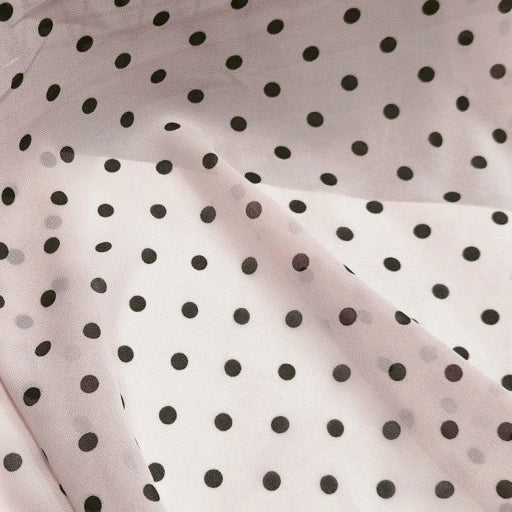 Light pink sheer Polka Dot Print Chiffon Fabric By The Yard featuring a black polka dot pattern.