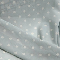 Light blue Polka Dot Print Chiffon Fabric By The Yard draped in soft, sheer folds.