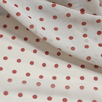 Polka Dot Print Chiffon Fabric By The Yard in sheer off-white with a repeating pattern of reddish-brown polka dots.