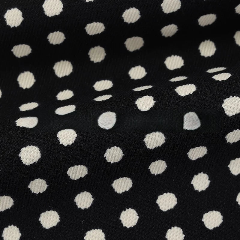 Elevate your projects with Longan Craft’s Polka Dot Print Corduroy Fabric By The Yard. This fine wale corduroy material features a retro-inspired, irregular white dotted pattern on a classic black background, creating gentle folds that add rich depth and texture to the surface.