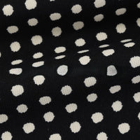 Elevate your projects with Longan Craft’s Polka Dot Print Corduroy Fabric By The Yard. This fine wale corduroy material features a retro-inspired, irregular white dotted pattern on a classic black background, creating gentle folds that add rich depth and texture to the surface.