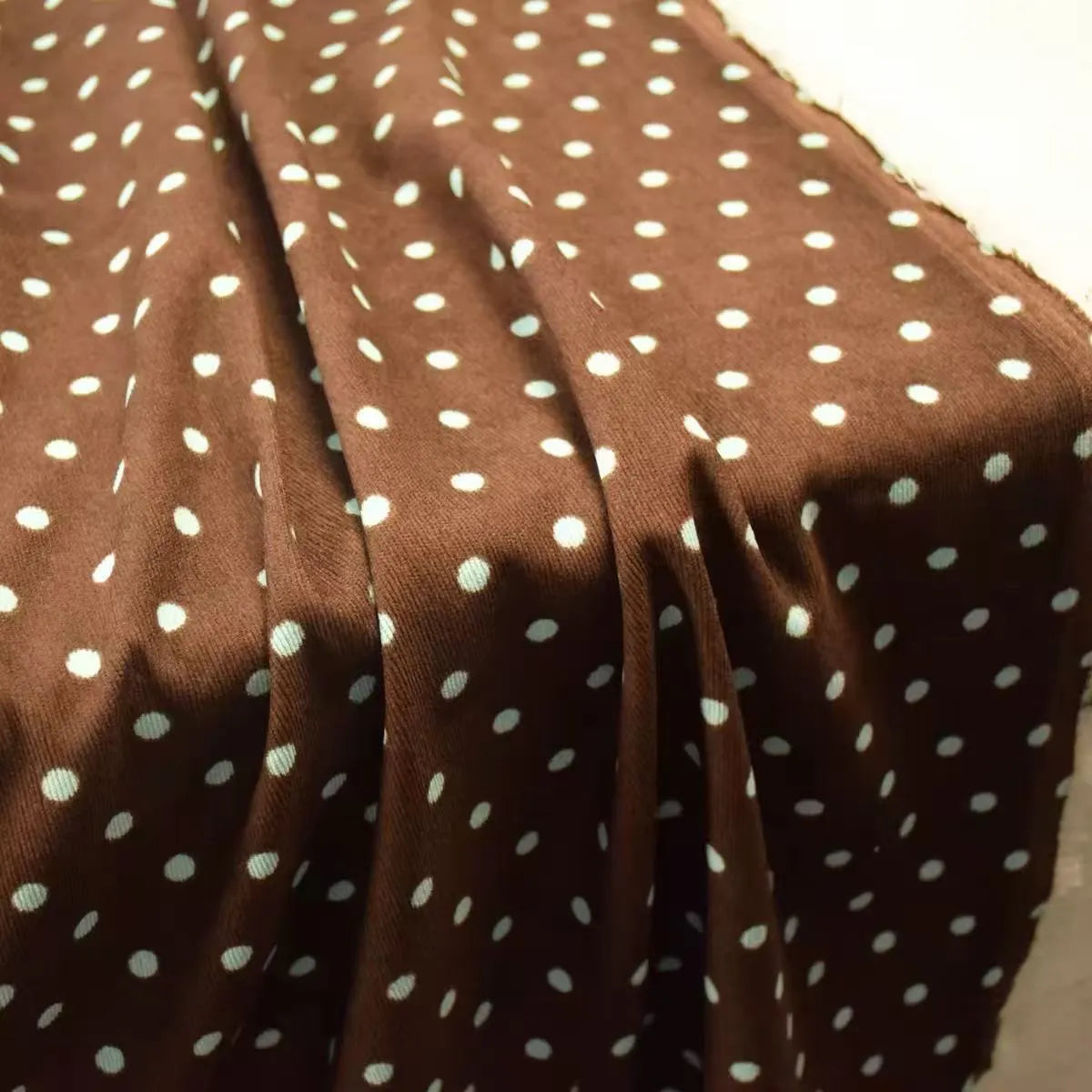 Brown Polka Dot Printed 21 Wales Corduroy Fabric By The Yard featuring a light blue polka dot pattern.