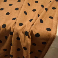 Tan Polka Dot Printed 21 Wales Corduroy Fabric by the Yard draped in soft folds.