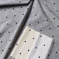 Polka Dot Printed Cotton 1*1 Rib Knit Fabric By The Yard in gray, cream, and white with a black polka dot rib knit pattern.