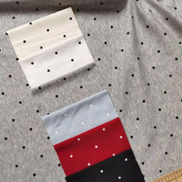 Polka Dot Printed Cotton 1*1 Rib Knit Fabric By The Yard background in gray, topped with folded swatches of white, light blue, red, and black printed cotton, each featuring a coordinating dot pattern.