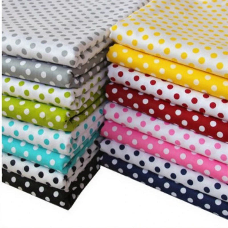 Neatly folded, Longan Craft's Polka Dot Printed Cotton Quilting Fabric features crisp white dots on twill cotton in grey, green, blue, yellow, red, pink, black, and navy—perfect by the yard for cozy quilts or clothing.