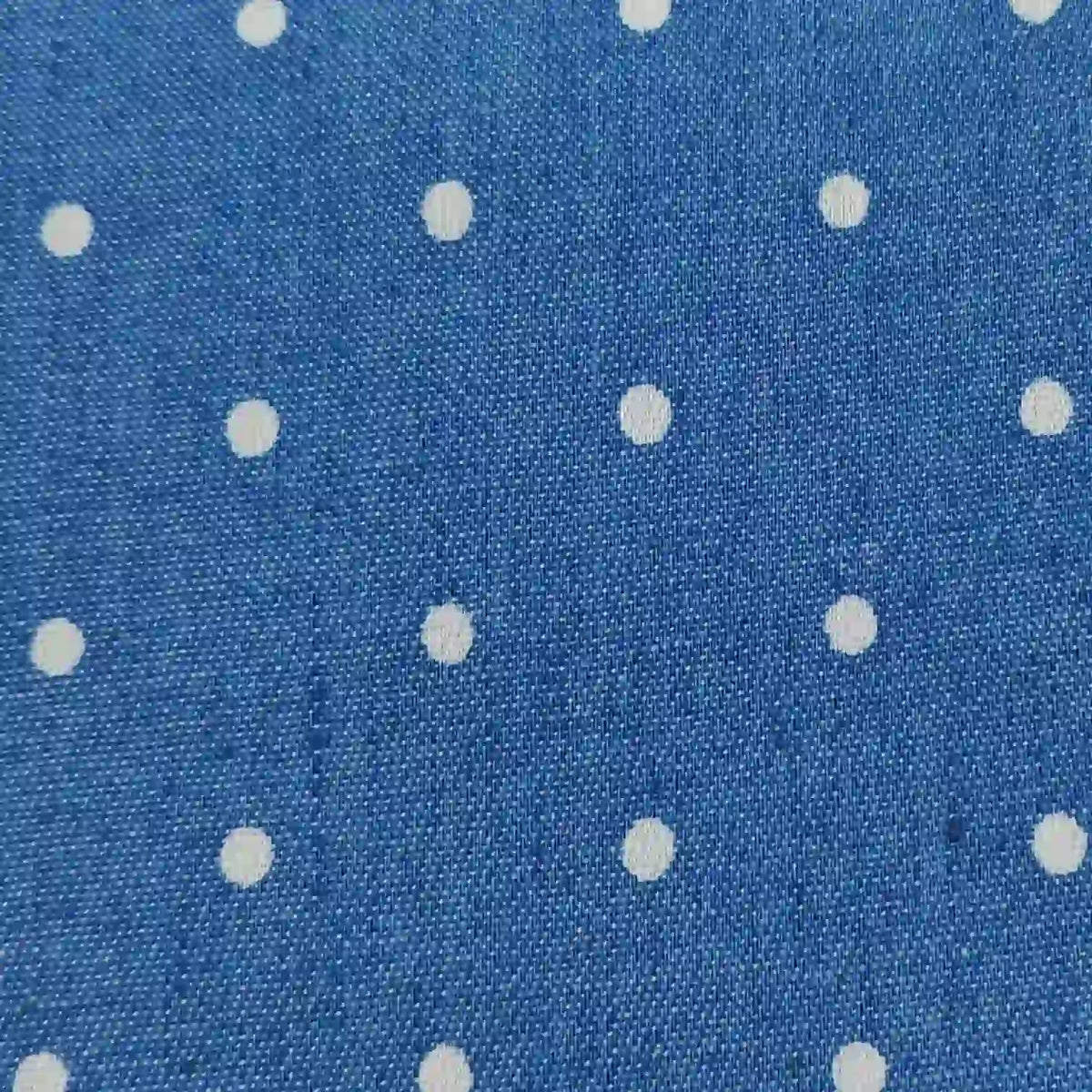 Polka Dot Printed Denim Fabric By The Yard featuring blue denim with a white polka dot pattern.