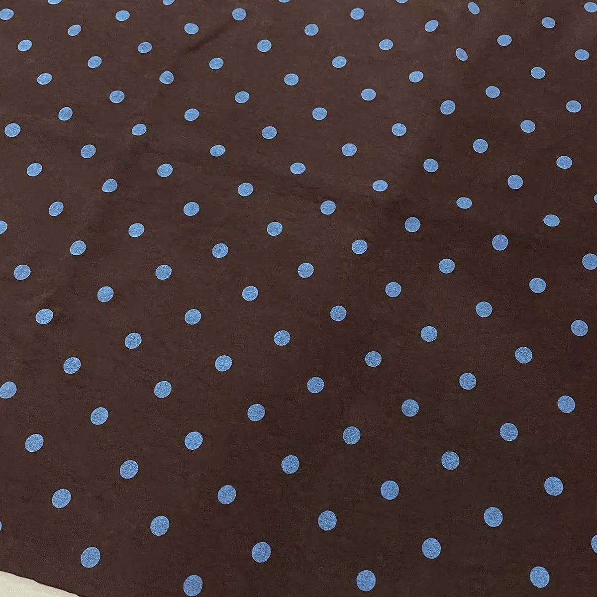 Polka Dot Printed Faux Suede Fabric By The Yard in brown with a repeating pattern of light blue polka dots.