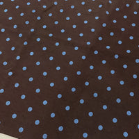 Polka Dot Printed Faux Suede Fabric By The Yard in brown with a repeating pattern of light blue polka dots.
