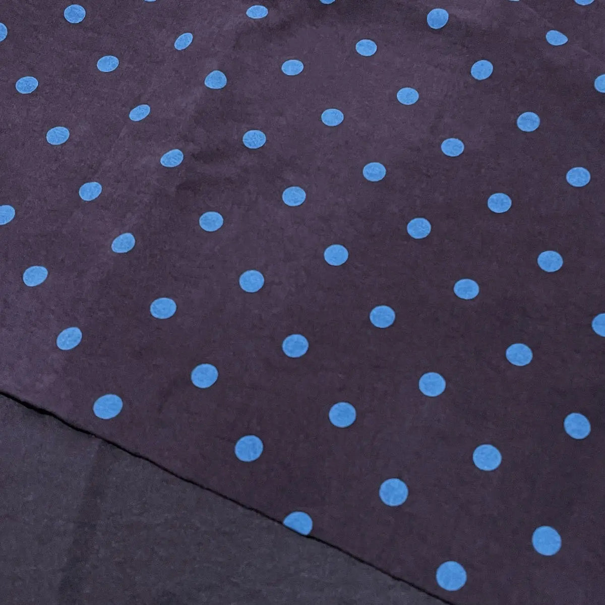 Polka Dot Printed Faux Suede Fabric By The Yard in dark faux suede featuring a repeating pattern of light blue polka dots.