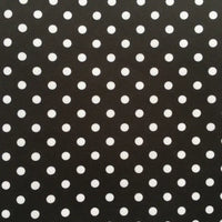 The Longan Craft Polka Dot Printed Peachskin Fabric by the yard features a black background with evenly spaced white polka dots, made from soft microfiber polyester—perfect for DIY skirts and stylish projects.