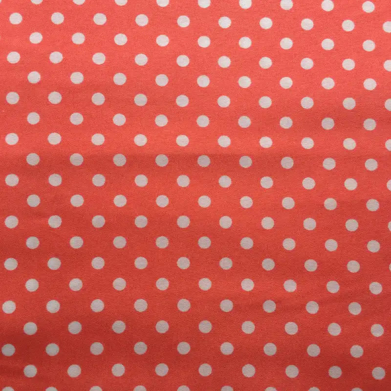 Longan Craft’s Polka Dot Printed Peachskin Fabric By The Yard features evenly spaced white dots on coral pink, made from soft microfiber polyester—perfect for DIY skirts and dressmaking projects.