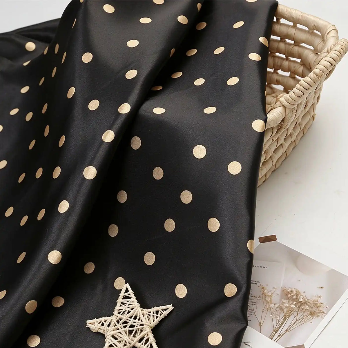 Polka Dot Printed Satin Fabric By The Yard draped over a woven basket.
