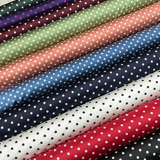 Longan Craft’s Polka Dot Stretch Silk Fabric By The Yard features white polka dots on green, pink, blue, red, black, and white 19 momme spandex silk—perfect for vintage clothing or elegant evening and bridal wear.