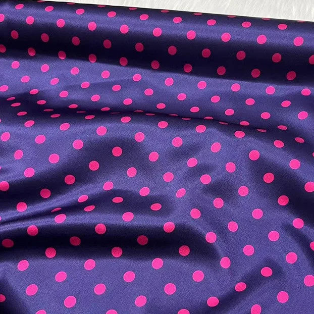 Longan Craft's Polka Dot Stretch Silk Fabric By The Yard features a dark purple background with bold pink polka dots and a shiny, drapable 19 Momme finish—ideal for chic bridal wear or elegant evening gowns.