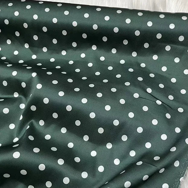 Longan Craft’s Polka Dot Stretch Silk Fabric By The Yard is a 19 momme spandex printed silk with dark green and white dots—perfect for vintage clothing or an elegant evening gown.