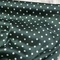 Longan Craft’s Polka Dot Stretch Silk Fabric By The Yard is a 19 momme spandex printed silk with dark green and white dots—perfect for vintage clothing or an elegant evening gown.
