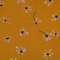 Polka Dot and Floral Printed Viscose Fabric by Longan Craft features abstract pink and white flowers with black centers on mustard yellow—perfect for creative sewing projects like long skirts. 100% viscose, available by the yard.