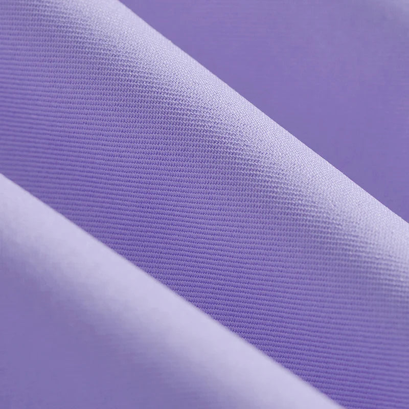 Close-up of folded light purple Longan Craft Polyester Gabardine Fabric By The Yard, featuring a fine twill weave and smooth, slightly ribbed finish—premium material perfect for stylish jackets and tailoring.