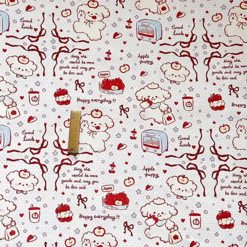 Puppy Apple Print Canvas Fabric By The Yard in white cotton canvas patterned with red line drawings of puppies, apples, ribbons, stars, and text including Good Luck, Happy everyday, and May the world be more gentle and may you be less sad.