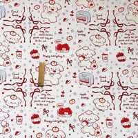 Puppy Apple Print Canvas Fabric By The Yard in white cotton canvas patterned with red line drawings of puppies, apples, ribbons, stars, and text including Good Luck, Happy everyday, and May the world be more gentle and may you be less sad.