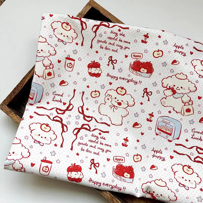 Puppy Apple Print Canvas Fabric By The Yard featuring white cotton fabric with a red line-art pattern of puppies, apples, hearts, and the text Happy everyday and May the world be more gentle.