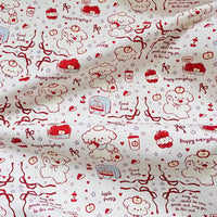 Puppy Apple Print Canvas Fabric By The Yard: off-white cotton canvas featuring a repeating red line-drawing pattern of puppies, apples, ribbons, and the text Happy everyday, Good luck, and May the world be more gentle and may you be less sad.