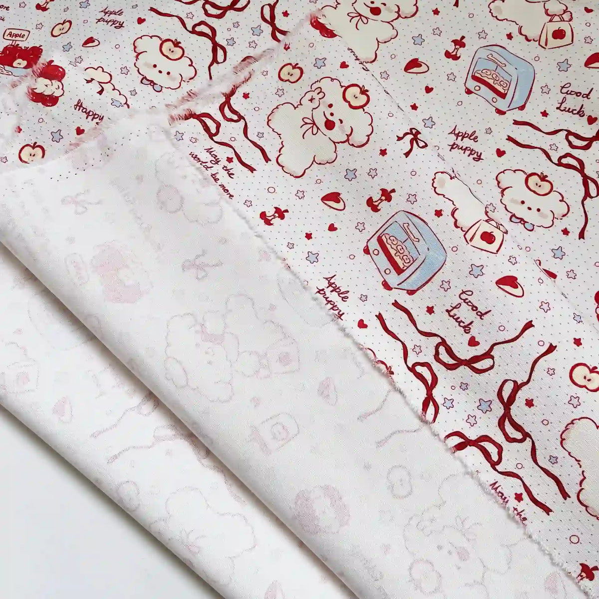 Puppy Apple Print Canvas Fabric By The Yard in white cotton canvas with a red line-art print of puppies, apples, small toasters, ribbons, and text reading Apple puppy and Good luck.