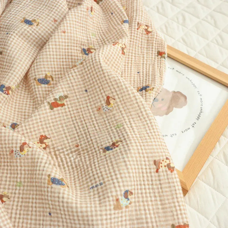 Longan Craft’s Puppy Print Gingham Double Gauze Fabric by the yard features a brown plaid pure cotton design with playful animal and people prints. This breathable material is perfect for baby clothes or sleepwear and adds a charming touch to any project.
