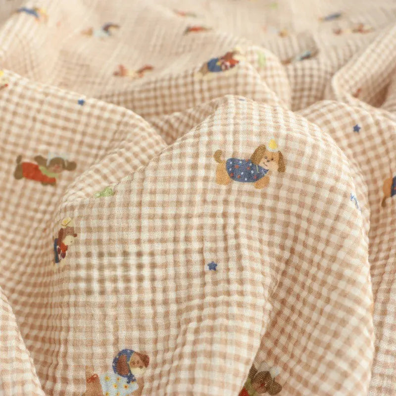 Longan Craft Puppy Print Gingham Double Gauze Fabric by the yard is a brown plaid pure cotton, breathable gauze material with playful cartoon puppies and blue stars—ideal for baby clothes and sleepwear.