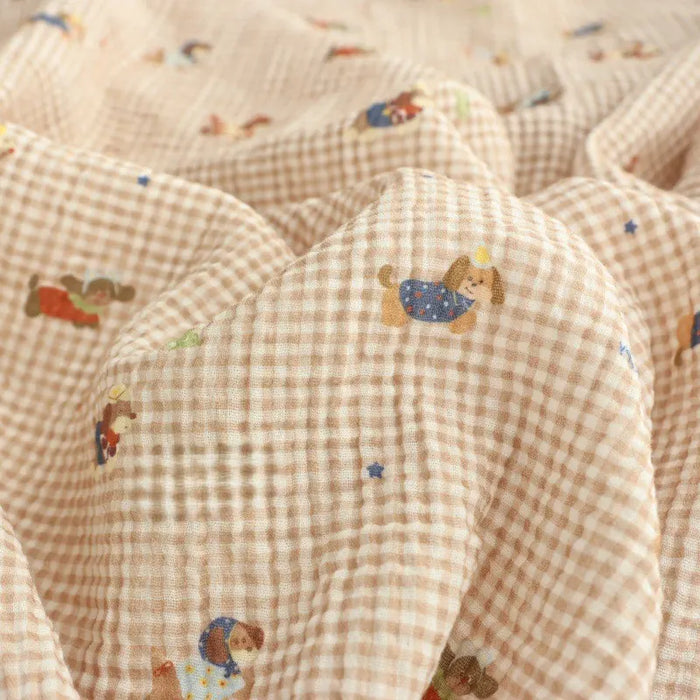 Longan Craft Puppy Print Gingham Double Gauze Fabric by the yard is a brown plaid pure cotton, breathable gauze material with playful cartoon puppies and blue stars—ideal for baby clothes and sleepwear.