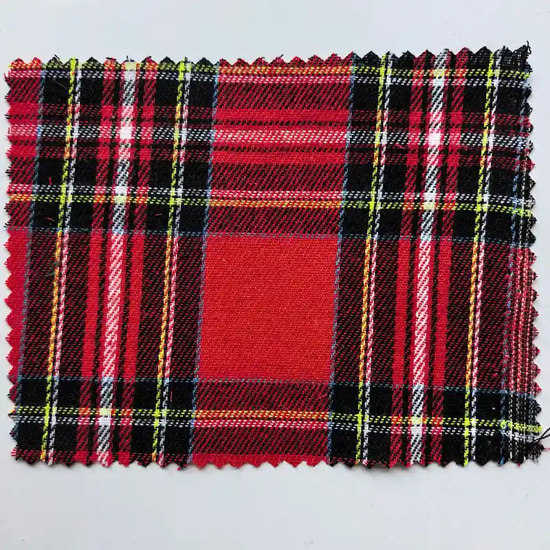 A rectangular swatch of Longan Craft Red Checked Cotton Flannel Fabric By The Yard—Scottish style, single-sided brushed flannel featuring black, yellow, and white stripes on a red check pattern, with pinked edges.