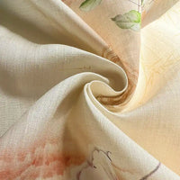 Close-up of Retro Botanical Printed Ramie Fabric by the yard from Longan Craft, featuring a chinoiserie floral print in subtle green, pink, and peach hues. The light beige ramie material is softly twisted to highlight its smooth texture and delicate drape—perfect for sewing blouses and other lightweight garments.