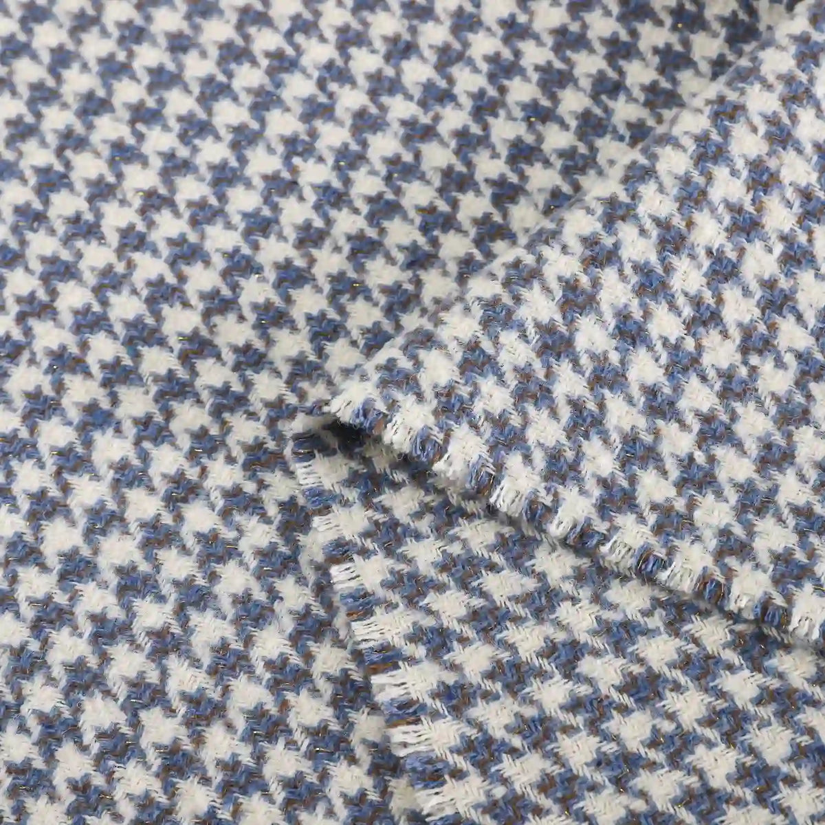 Close-up of Longan Craft’s Retro Houndstooth Jacquard Tweed Fabric by the yard, a vintage-inspired blue and white wool polyester blend showing its textured, woven pattern with two overlapping pieces.