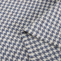 Close-up of Longan Craft’s Retro Houndstooth Jacquard Tweed Fabric by the yard, a vintage-inspired blue and white wool polyester blend showing its textured, woven pattern with two overlapping pieces.
