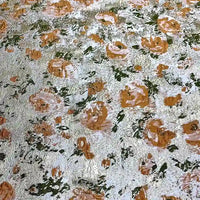 Close-up of the Rose Jacquard Brocade Fabric by Longan Craft, featuring golden metallic floral patterns in peach and green on a textured background—perfect for elegant upholstery or retro formal dresses. Available by the yard.