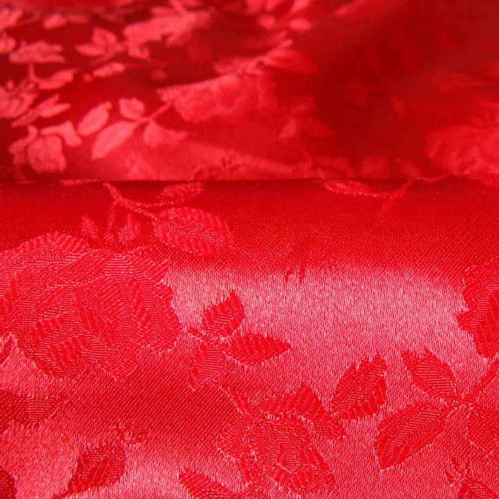 Close-up of Longan Craft Rose Jacquard Satin Fabric By The Yard, a colorful polyester floral jacquard satin with roses and leaves. This smooth, shiny fabric is ideal for costumes and elegant textile projects.