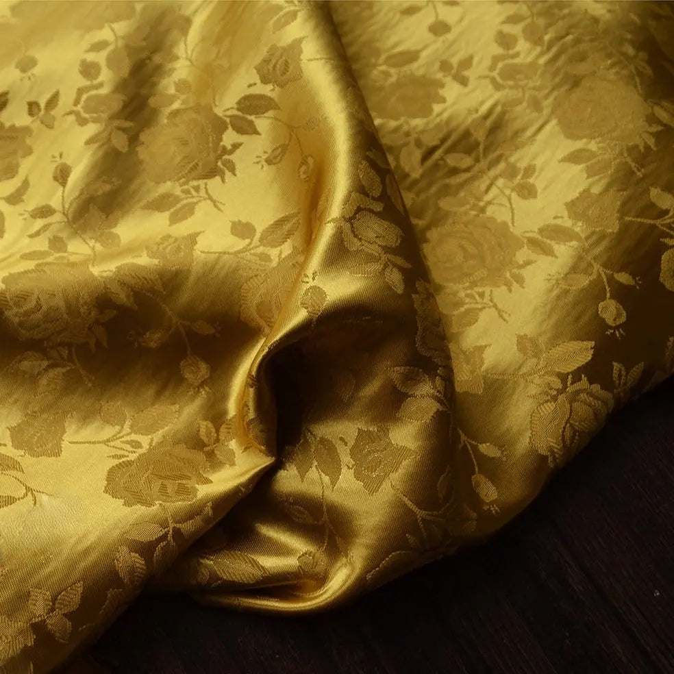 A close-up of Longan Craft's Rose Jacquard Satin Fabric shows its colorful floral polyester pattern and shiny, textured finish, softly draped to highlight the ideal costume material.