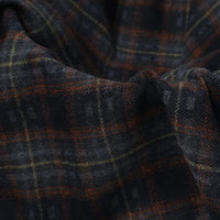 Semi Worsted Plaid Wool Fabric By The Yard in dark charcoal with a plaid pattern of rust orange and yellow lines.