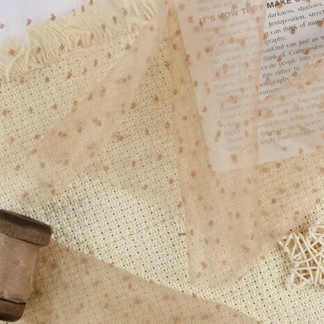 Sheer, lightweight Longan Craft Sheer Swiss Dot Organza Fabric By The Yard featuring a pattern of small, raised colorful dots with frayed edges.