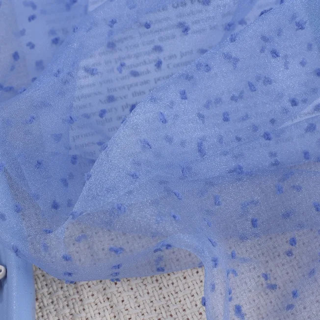 Sheer blue Swiss Dot organza fabric by the yard featuring small, raised blue dots throughout.