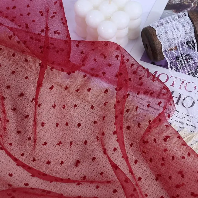 Sheer red Sheer Swiss Dot Organza Fabric By The Yard featuring a pattern of raised, darker red dots.