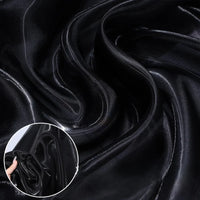 Close-up of Shiny Liquid Organza Fabric By The Yard from Longan Craft, featuring a colorful glossy finish with smooth folds—perfect for luxury gowns. Inset shows the semi-transparent textile being held and gently crumpled by hand.