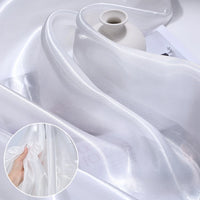 A sheer Shiny Liquid Organza Fabric By The Yard from Longan Craft with a colorful glossy finish drapes over a small matte white vase; inset shows its lightweight, translucent luxury—perfect for bridal or evening gowns.