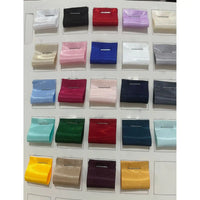 A display card from Longan Craft shows 24 neatly arranged rectangular swatches of Shiny Liquid Satin Fabric By The Yard in assorted solid colors, each pinned in place—perfect for formalwear and bridesmaid dresses.