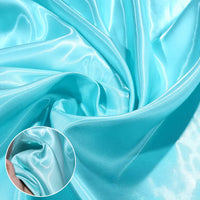 A close-up of Longan Craft's Shiny Liquid Satin Fabric By The Yard in light blue displays its glossy finish and gentle folds, with an inset showing a hand pinching the soft, silky premium polyester—ideal for bridesmaid dresses and formalwear.