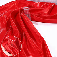 Shiny Liquid Satin Fabric by the Yard from Longan Craft, shown in red, draped over a clear glass vase with a close-up inset highlighting its smooth, reflective texture—ideal for solid color bridesmaid dresses and formalwear.